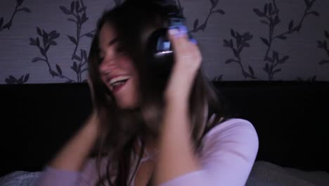 Happy-teenage-girl-dancing-in-her-room-with-headphones-listening-to-music