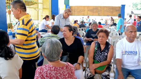 Enrolled-senior-citizens-line-up-to-receive-their-monthly-cash-allowance-in-Cebu-City,-Philippines