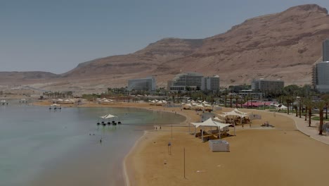 Aerial-View-of-the-Dead-Sea-Beah-Resort-in-Israel-with-red-mountains-in-the-background
