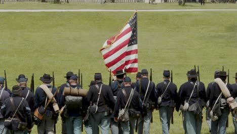 American-Civil-War-reenactors-as-Union-soldiers-walk-in-a-line-with-the-American-flag-at-the-Ohio-History-Center