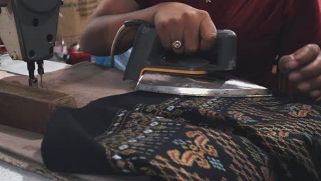 Seamstress-Ironing-a-Finished-Garment-at-the-Market
