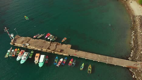 Aerial-view-of-fishing-boats-selling-their-catch-alongside-the-jetty-in-the-Gouyave-fish-market-located-on-the-Caribbean-island-of-Grenada-also-known-as-the-spice-island