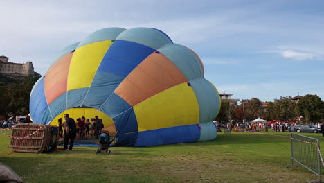 people-preparing-for-hot-air-balloon-festival,-still-eye-level-shot