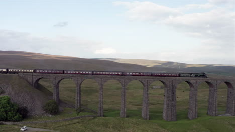 Aerial-Tracking-Shot-of-the-Flying-Scotsman-60103-Steam-Train-as-it-Passes-Over-Ribblehead-Viaduct-in-North-Yorkshire-with-Medium-Crop