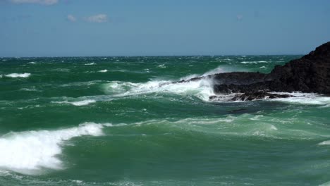 Closeup-of-waves-crashing-into-the-coast-rocks-of-Collioure-in-the-Mediterranean-on-a-summers-day-with-very-high-gusting-winds