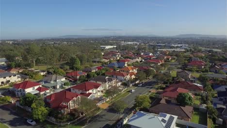 Gliding-aerial-drone-shot,-flying-over-a-a-typical-quiet-Australian-suburb