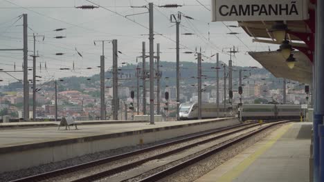 Gray-train-leaving-train-station-in-Campanhã,-Porto,-Portugal
