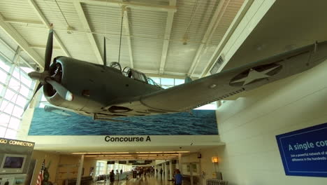 Dauntless-Dive-Bomber-aircraft-model-hangs-from-the-ceiling-at-Midway-international-airport,-Chicago,-Usa,-United-States,-Memorial-exhibit,-art,-decoration,-war-plane