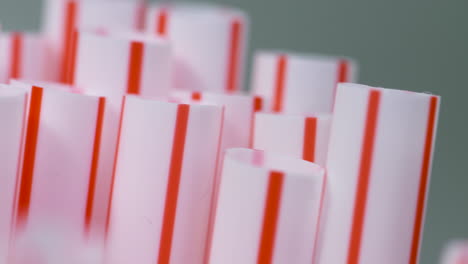 Macro-close-up,-a-bunch-of-red-and-white-single-use-plastic-straws
