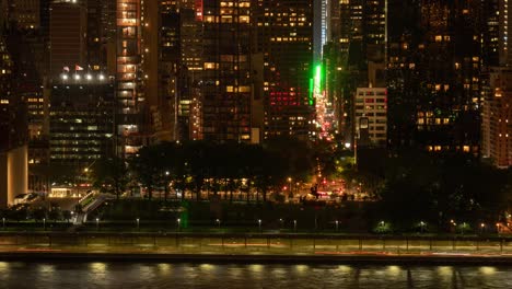 Time-Lapse-of-traffic-at-the-intersection-of-FDR-Drive-and-UN-Building-and-East-47th-Street-at-Night-in-Manhattan,-New-York-City