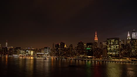 Time-Lapse-of-Manhattan,-FDR-Drive-and-East-River-between-One-World-Trade-Center-and-the-Chrysler-Building-at-dusk-and-night,-shot-from-Long-Island-City,-New-York-City