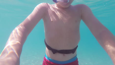 Underwater-Footage-of-Kid-Snorkeling-at-Kalamata-Beach,-Greece