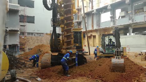 2-Construction-workers-assist-deep-foundation-drilling-on-a-building-site-or-construction-site-in-Cape-Town-South-Africa