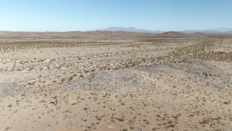Aerial-revealing-shot-of-the-vast-Mojave-desert-near-interstate-15