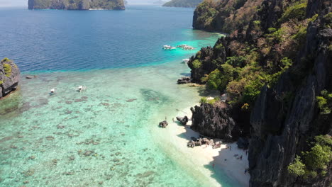 Majestic-aerial-panning-view-of-tropical-islands,-mountains-and-emerald-sea,-El-Nido,-Palawan,-Philippines