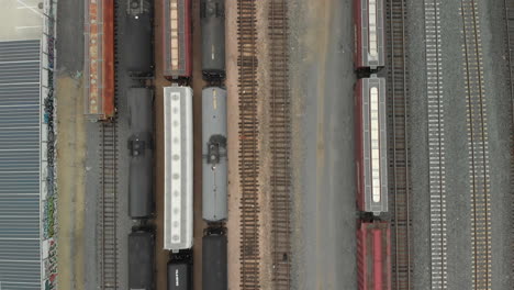 Top-Down-Aerial-of-Train-Cars-Parked-in-Railway-Station