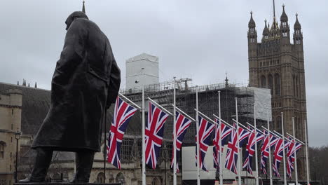 British-Union-Jack-Flags-Hang-From-Flag-Poles-Behind-the-Winston-Churchill-Statue-on-Parliament-Square-the-day-before-the-UK-was-due-to-leave-the-European-Union
