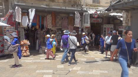 Tourists-and-locals-on-the-street-inside-the-city-walls-of-Jerusalem,-Palestine