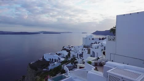White-buildings-of-Santorini-during-a-romantic-sunset-with-the-ocean-and-the-islands-in-the-background