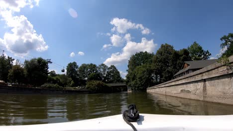 Timelapse-video-of-a-motorboat-sailing-through-the-lake-in-a-leisure-park-look-from-inside-the-boat