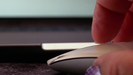 Close-up-first-person-view-of-fingers-scrolling-and-clicking-on-a-white-computer-mouse