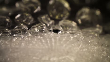 pushing-into-a-bubble-wrap-bag,-top-details---textures-of-the-bubbles-are-visible