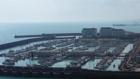 Rising-establishing-shot-of-sail-boats---yachts-moored-in-Brighton-Marina,-Southern-UK-on-a-calm-summers-day