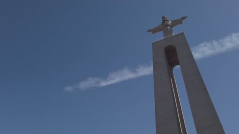 Pan-right-to-reveal-Christ-the-King-statue-in-Almada,-Portugal