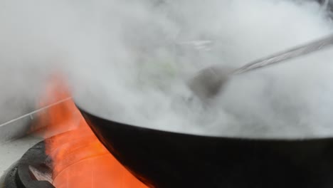 Chef-Cooking-Stir-Fried-Dish-In-Wok---close-up