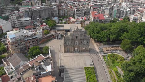 Tilt-reveal-aerial-view-of-famous-Ruins-of-Saint-Paul's,-Macau-on-sunny-evening