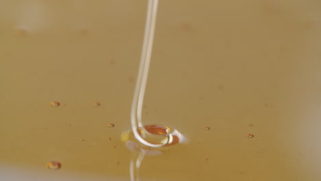 High-angle-shot-of-honey-flowing-into-more-honey