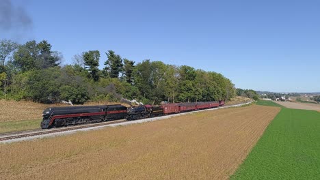 An-Aerial-View-of-Two-Norfolk-and-Western-Steam-Locomotives-Steaming-Up-on-Two-Tracks-in-the-Countryside