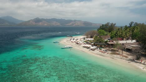 Flying-Over-White-Sand-Beach-and-Coral-Reefs-in-Sea-of-Tropical-Island,-Bali-Indonesia,-Gili-Air