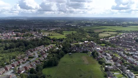 Left-to-right-aerial-shot-above-town-near-Wrexham,-North-Wales