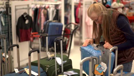 Closeup-of-a-woman-looking-through-luggage-in-a-store