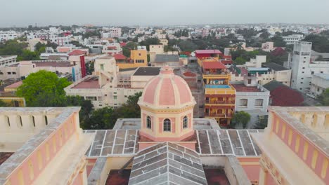 Top-Angle-Close-Up-Aerial-Reveal-Shot-of-Our-Lady-Angeles-Church-on-a-Cloudy-morning-near-the-french-town,-Puducherry-shot-with-a-drone-in-4k