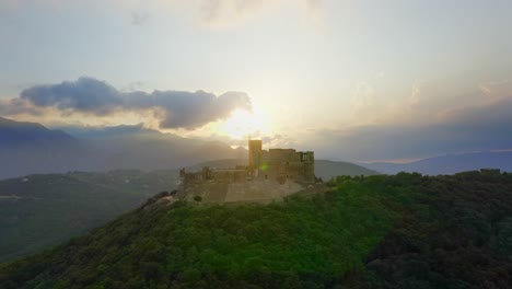 Aerial-right-to-left-tracking-shot-of-Montsoriu-castle-in-Catalonia,-Spain,-at-sunset
