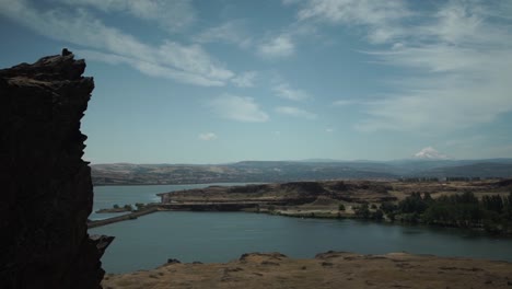 Slow-panorama-of-the-Columbia-River-and-Mount-Hood-Oregon-seen-from-Horse-Thief-Butte,-blue-skies,-high-clouds