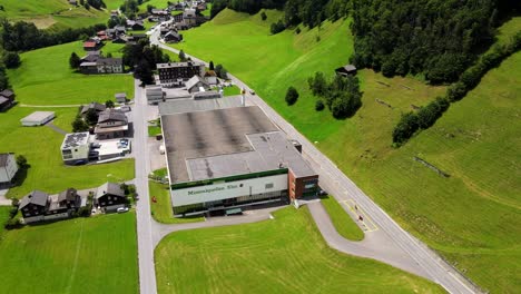Cinematic-aerial-orbiting-shot-of-mineral-water-plant-in-Elm,-Glarus,-Switzerland