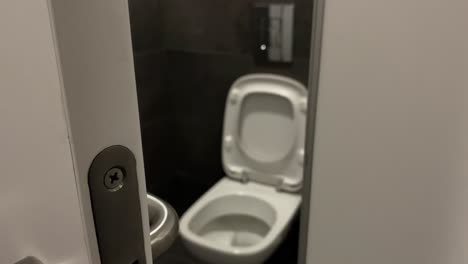 Close-up-on-handle-and-door-lock-in-public-toilet