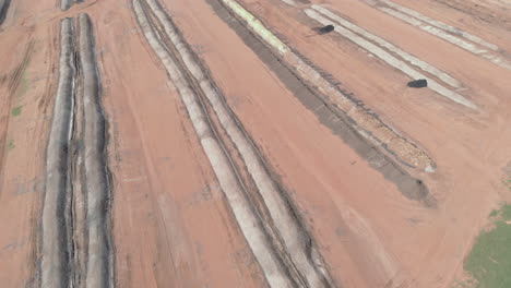 aerial-view-of-sugar-cane-bagasse-deposit,-used-to-fertilize-the-field-and-plantation