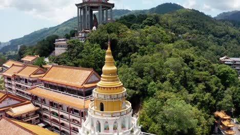 Kek-Lok-Si-Buddhist-temple-with-pagoda,-shrines-and-Kuan-Yin-statue-enclosure-visible,-Aerial-drone-pan-left-reveal-shot