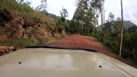 Hyperlapse-along-dangerous-narrow-mountain-road-in-Rwanda,-dirt-tracks-through-villages