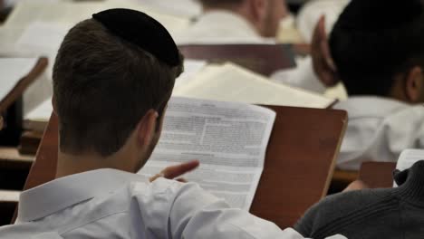 Young-Jewish-man-concentrating-on-studying-Torah-in-yeshiva-religious-school