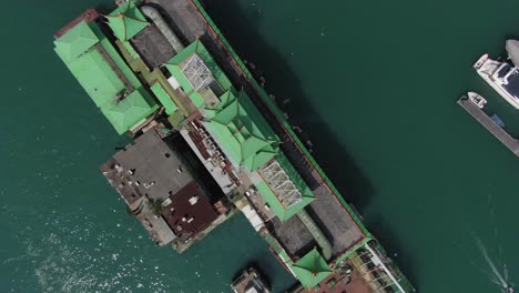 Jumbo-floating-restaurant-structure-and-roof-top-in-Hong-Kong-Aberdeen-Harbour-typhoon-shelter,-Pull-up-Aerial-view