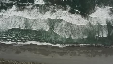 Ocean-beach-drone-footage-overhead-of-waves-crashing-into-shore