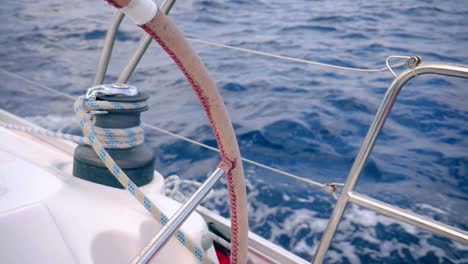 View-of-sea-through-steering-wheel-of-forward-propelling-yacht