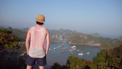 Back-View-Of-A-Man-Looking-At-The-View-In-Catba-island-in-Vietnam---Beautiful-Tourist-Destination---Aerial-Shot