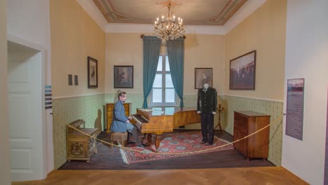 Well-dressed-Man-Stops-Playing-The-Piano-And-Walks-Out-of-The-Exhibition-In-The-Hugo-Wolf-Museum-In-Slovenj-Gradec,-Slovenia