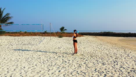 Beautiful-morning-on-seaside-of-Thailand-with-paradise-white-beach-where-athlete-girl-exercising-gymnastics-and-weight-lifting